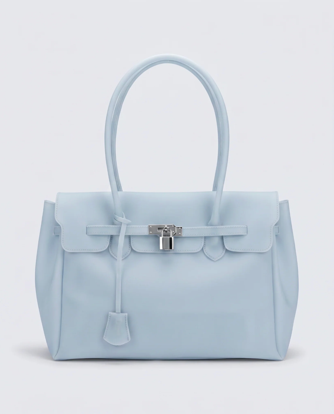 A light blue jelly handbag with a structured rectangular shape, dual top handles, a front flap, and a silver padlock closure on a light gray background.