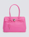 A bright pink jelly handbag with silver-tone hardware, featuring a front flap, top handles, and a hanging clochette, photographed against a light gray studio background.