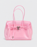 A shiny light pink translucent tote bag with double top handles, a front flap, and a silver padlock closure, photographed on a clean light gray background.