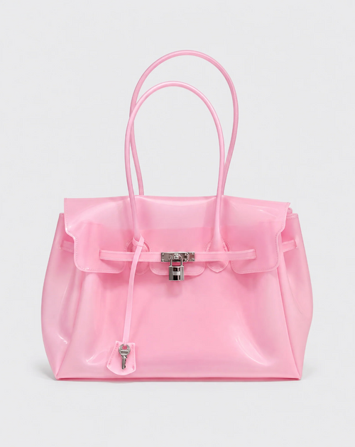 A shiny light pink translucent tote bag with double top handles, a front flap, and a silver padlock closure, photographed on a clean light gray background.